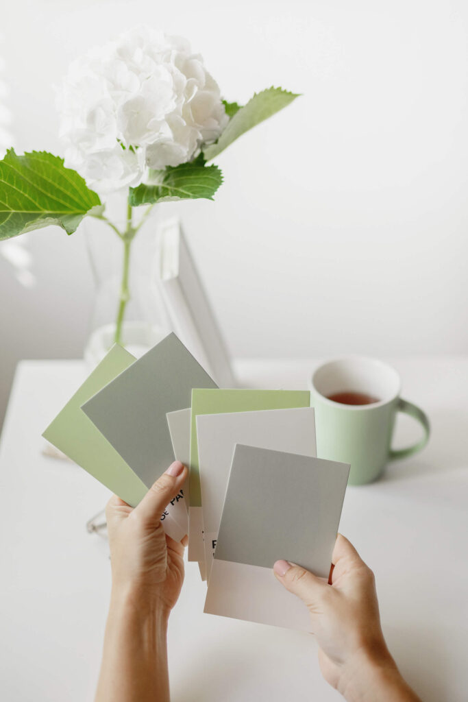Green and gray swatches being held up